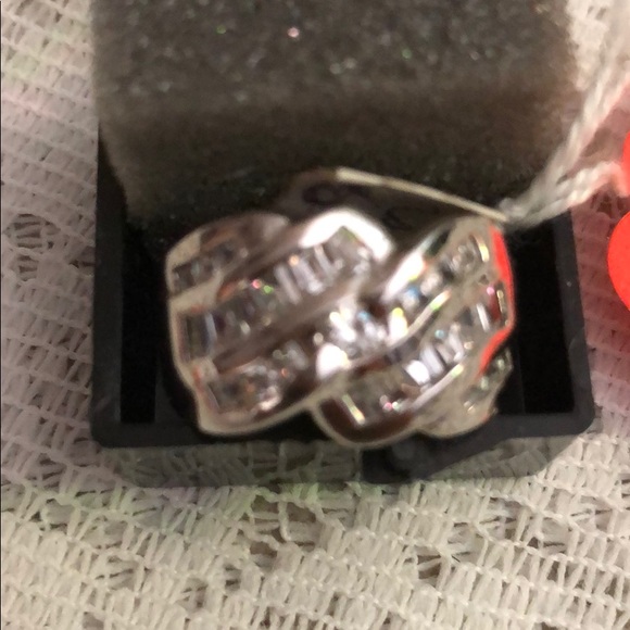 Ring Made of 9/5 Silver; and imitation diamond.